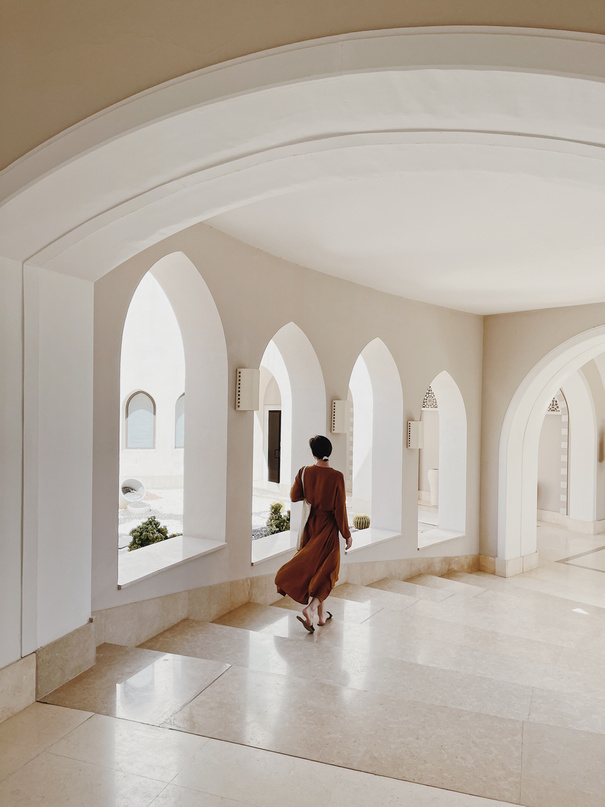 Woman Walking through the Bright Hall in Modern Building 